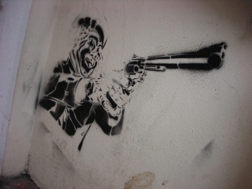 Graffiti of clown with a pistol