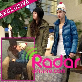 
Justin Bieber and Selena Gomez are steaming up their relationship again in the cold winter weather and RadarOnline.com has exclusive new photos of their PDA packed holiday trip together! The love birds are giving their relationship another try and they were snuggling in the airport in Salt Lake City, Utah in the photos and Selena, 20, is sitting on Justin’s lap and they have their arms around each other in the shots. They seem to be deep in conversation but Justin, 18, sticks his tongue out at Selena which makes her smile.

“They were very affectionate with each other,” the eyewitness told RadarOnline.com. “They were kissing on and off and they just sat together and talked and looked totally in love.” 

Justin and Selena were rumored to have been vacationing with her bestie Taylor Swift, who is in the ski resort town with her new boyfriend, One Direction’s Harry Styles. If Justin asked Santa to bring his girlfriend back for Christmas it seems like he got his present a few days early!
