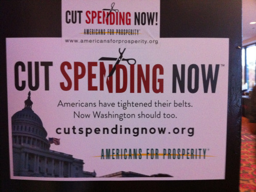 'CUT SPENDING NOW' sign at Americans For Prosperity conference