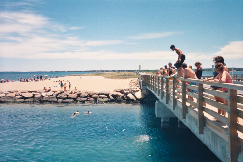 a group of people on a bridge over water