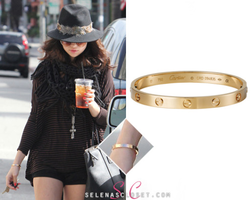 Selena Gomez hid under her fedora and glasses today as she stepped out for a drink at Panera Bread. She wore a Cartier LOVE Bracelet in color Pink Gold, which she also wore at her Nylon Magazine dinner. This bracelet can be yours for a pricey $5,850. <br /> Buy it HERE <br /> Thanks gangstajustin! <br /> If you&#8217;re after a cheaper alternative, this Michael Kors Buckle Bangle only costs $95.00! <br /> She&#8217;s also wearing a Forever 21 hat, Free People necklace and carrying her Dolce &amp; Gabbana handbag. We&#8217;re still looking for the rest of her outfit.