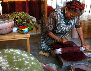 I will be visiting the Tlapanochestli cochineal farm to learn more about natural dyes and do research. SO EXCITED!  
Here she is grinding the cochineal insects (which are actually considered pests in Southern CA but that are cultivated on the Mexican cacti farm) into a thick paste that can then be used as dye material.