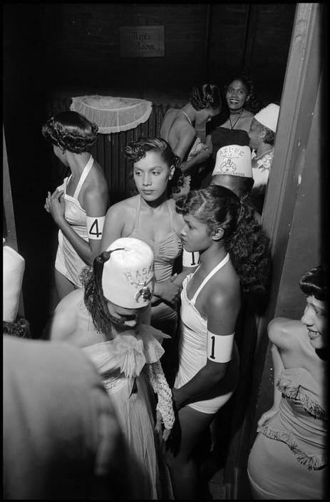 vintageblackglamour:
Beauty contestants backstage at a pageant sponsored by the Shriners in Harlem, 1951. Photo: Burt Glinn/Magnum Photos.
