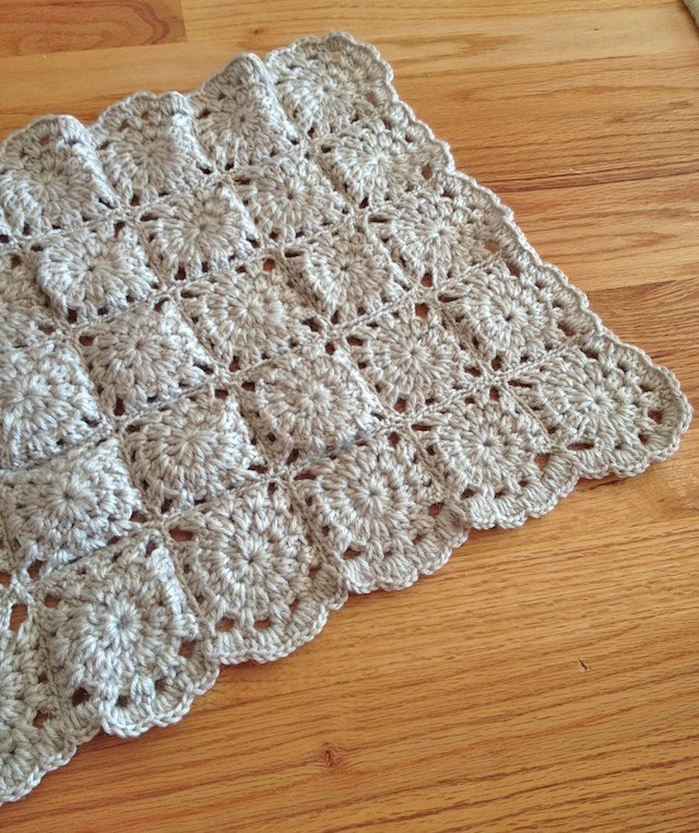 crocheted baby blanket in grey