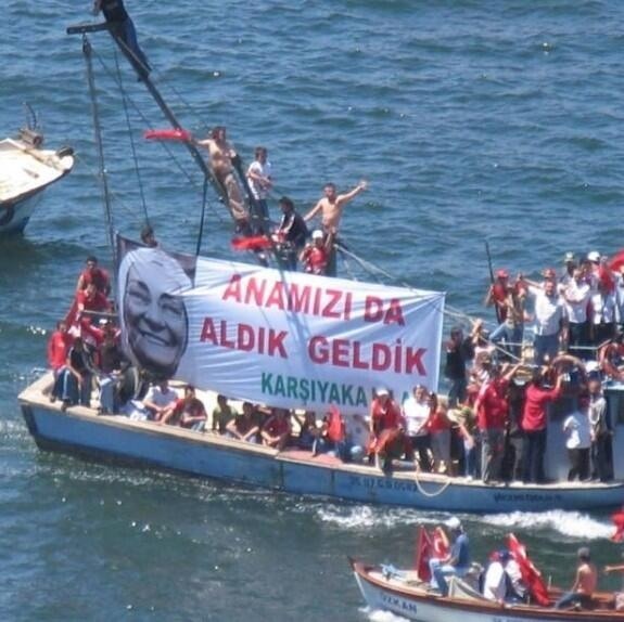 People arrive at Izmir city center  by boats where protests are scheduled for this evening.