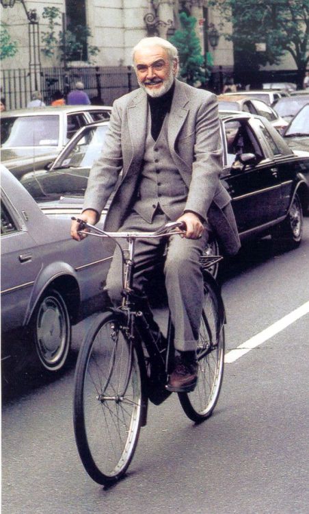 Sean Connery rides a bike.