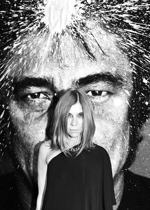 Carine Roitfeld in front of a picture of Benicio Del Toro by Raphael Marcuzzo at the Ermanno Scervino party during Milan fashion week. Photo by Stephane Feugère