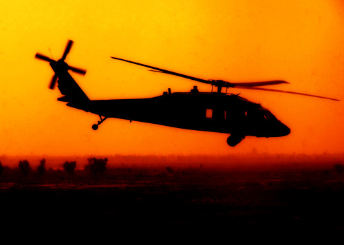 Blackhawk helicopter silhouetted at sunset