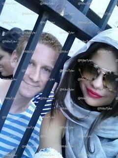 Selena posing with a fan.
