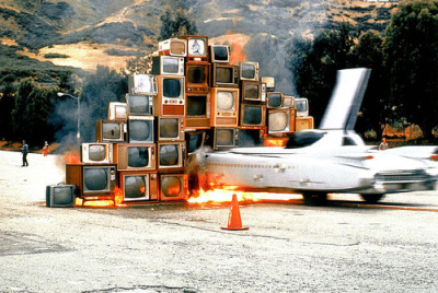 via michaelcharles & magnificentruin:  July 4, 1975: Ant Farm’s Phantom Dream Car is driven through a wall of burning TV sets at San Francisco’s Cow Palace