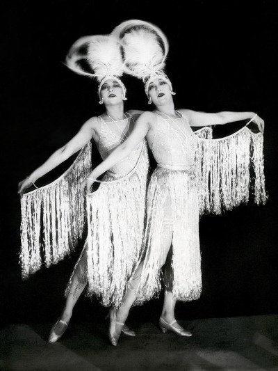 The Dolly Sisters, Rosie and Jenny
The Dolly Sisters, twins Rosika (Rose) and Jansci (Jenny)  Deutsch, were born October 25, 1892 in Hungary,  and emigrated to the United  States in 1905. They perfected a single-sex &#8220;tandem&#8221; dance act -  practising in front of mirrors - under the name of &#8216;The Dolly Sisters&#8217;  they began earning money in beer halls as early as 1907. Barred for  being under age by the New  York City stage, they toured the Orpheum circuit until 1909 when  they debuted on the Keith vaudeville circuit till 1911 when they signed with the Ziegfeld Follies for two seasons.  It was                        here that they got their theme &#8230; &#8220;Siamese  Twins,&#8221;                        which they used throughout their career.
In addition to making about a half dozen films from 1913 to 1920,  they toured the theatres and dance halls of Europe.