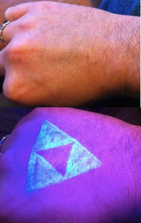 A blacklight Triforce Legend of Zelda duh tattoo
