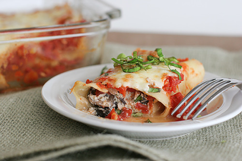 Spinach and Mushroom Cannelloni with Ricotta Cheese
**Made this tonight for dinner. It was soooo good! I would definitely double the amount of spinach the recipe calls for. I also used an entire box of sliced mushrooms from my grocery store instead of the 2 cups it called for. Besides that, it is perfect! I love the marinara sauce but I would probably add more crushed pepper next time. All-in-all, it was definitely worth making!**
{via Taste and Tell Blog}serves 6-8total time:  about 1 hour
Filling:2 tablespoons olive oil1 small onion, chopped1 garlic clove, minced3 cups fresh spinach2 cups sliced mushrooms1 1/2 cups ricotta cheese1/2 cup shredded mozzarella cheese1/4 cup shredded Parmesan cheese1 large egg, beaten1 teaspoon dried basil1/2 teaspoon dried oregano1/4 teaspoon black pepper1/2 teaspoon salt
Marinara:1 tablespoon olive oil1/2 small onion, chopped2 garlic cloves, mincedDash crushed red pepper3 (15 ounce) cans diced tomatoes1 tablespoon tomato paste3 tablespoons chopped fresh basilSalt and pepper, to taste
Pasta:1 box No-Boil Lasagna Noodles
Topping:1 1/2 cups shredded mozzarella cheeseDirections: 
Preheat the oven to 350F. Prepare a 9×13 baking dish by spraying it with cooking spray.
Make the filling: Heat the olive oil in a large saute pan over medium-high heat. Add the onion and garlic and cook until tender. Stir in the spinach and mushrooms. Cook until the mushrooms are soft and the spinach is wilted; remove from heat. While it is cooking, combine the ricotta, mozzarella, and Parmesan in a large bowl. Add the egg and mix in. When the spinach/mushroom mixture is finished cooking, mix it in along with the seasonings. Set aside.
Make the marinara:  Heat the olive oil in a large saute pan over medium-high heat.  Add the onion and garlic and cook until the onions are soft.  Stir in the tomato paste and let cook for 60 seconds.  Stir in the red pepper flake and the diced tomatoes.  Add the basil and season to taste with salt and pepper.  Let simmer and cook down slightly for about 20 minutes.
While the sauce is cooking, bring a large pot of water to a boil and season with salt.  Add the pasta and cook for 5 minutes.  (The noodles will not be cooked all the way through, but will finish cooking in the oven.)  Carefully remove them from the water and lay them flat on a wire cooling rack.
To assemble:  Take about 1/2 cup of the marinara sauce and spread it in the bottom of the prepared baking dish.  Spread about 1/4 cup of the ricotta mixture on the short side of each lasagna noodle.  Put 1 tablespoon of the marinara on top of the ricotta mixture, then roll up the noodle.  Transfer to the baking dish with the seam side down.  Continue will all of the noodles and filling.  Top with the remaining sauce and the mozzarella cheese.  Cover pan with foil.
Bake for 30 minutes, or until the sauce is bubbling.  Remove the foil and bake for until the cheese has browned and is bubbling, about 5 minutes.