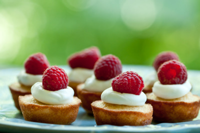 gastrogirl:

financiers with whipped cream and raspberries.
