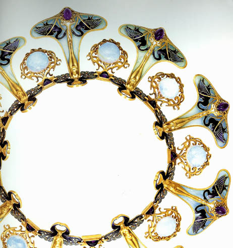 “Lalique designed one of his most famous and incredible necklace for the Parisian exposition.  Handcrafted in gold with nine nude female figurines standing on amethyst stones with black swans on each side of her feet, in between the figures are round opals all suspended from an ornately curved enameled neck ring.”