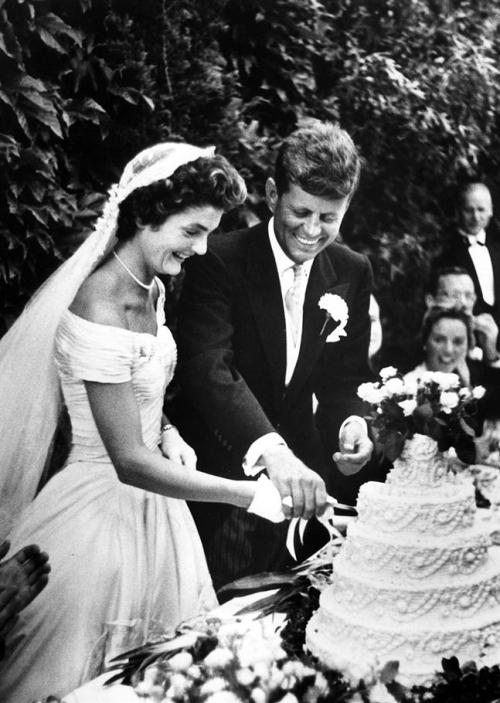 John F. Kennedy and Jacqueline Bouvier cut their wedding cake, 1953.