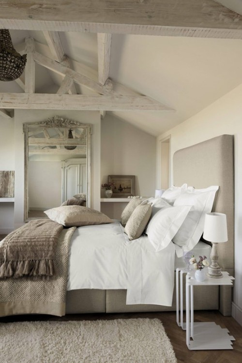 A beautiful light and airy bedroom decorated in...