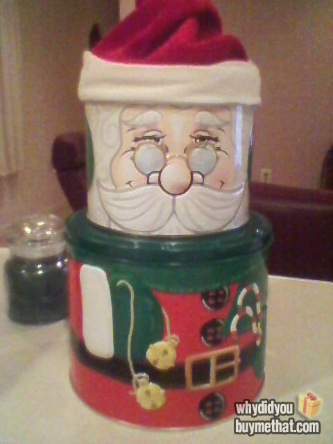 This is a Santa tin I received at a Christmas gift swap.  I saw his smug face and smudged hat and was a bit disappointed but thought that there would at least be cookies or something inside. It didn’t have anything other than crumbs and a couple sprinkles in it.  I got crumbs for Christmas.  Who gives a used cookie tin as a gift?! -Amber