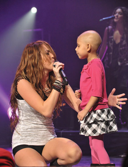 
Even if you are not a miley blog everyone should reblog this, see that little girl right there? she had cancer and died 2 weeks later, but miley made that little girls dream come true. to sing on stage with her idol. Miley Ray Cyrus.
