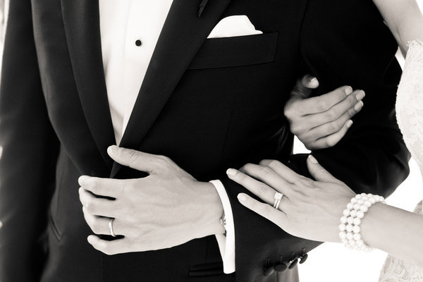 Black and white wedding photo of bride and groom rings paris