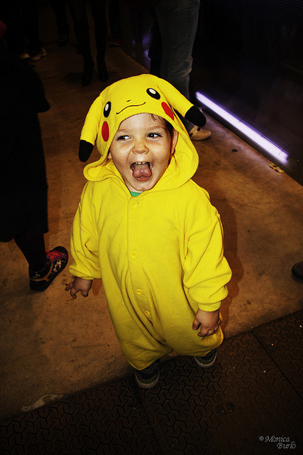 [Description: A toddler is dressed as pikachu from Pokemon. He&#8217;s sticking his tongue out in pleasure.]