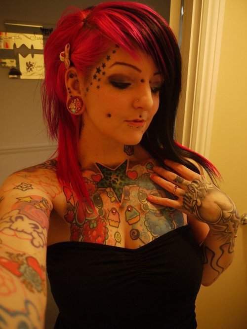  female tattoos girl piercings chest tattoos skull and crossbones 