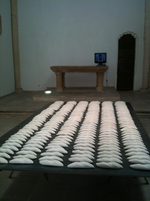 The huge iron table in the centre covered with meticulously lined up rows of white bread (of hand made plaster) creates a huge impact as you enter the oratory with its religious connotations. Viquez has called it &#8216;Pan para hoy&#8217;.  There  is a traditional Spanish saying that to be born with a loaf of bread under one&#8217;s arm means to be born fortunate. The symbolism is poignant in these troubled times - the austerity of the room is a foil to the abundance of the bread. The effect is astonishing.
