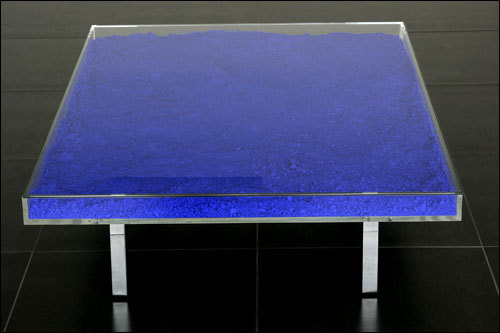 Artist Yves Klein patented his own color, International Klein Blue (IKB), in 1960. The next year, he designed a low, simple form table filled with the pigment.
 
Beginning in 1963, Yves Klein&#8217;s widow, Rotraut Klein-Moquay supervised an edition of the table that came in three options: &#8216;Table Bleue&#8217; (filled with Klein International Blue pigment), &#8216;Table Rose&#8217; (with rose madder) and &#8216;Table D&#8217;Or&#8217; (containing 3000 sheets of gold leaf). 