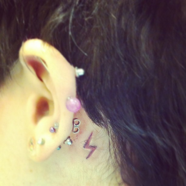 scar tattoo behind my ear.