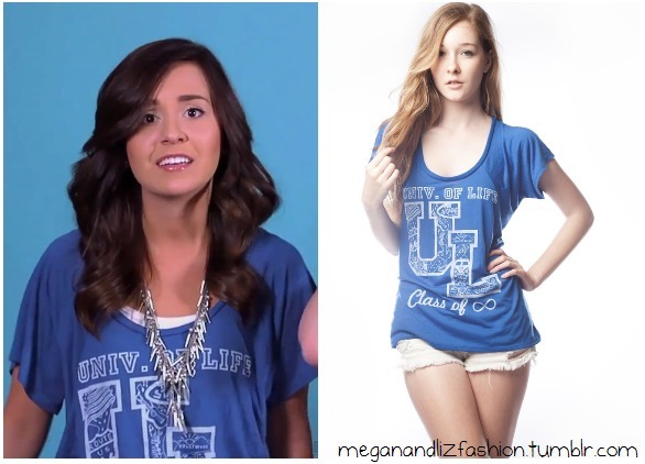 Megan wears this top in their July Updates Video. (watch it here).  Its a blue top with University of Life printed on itBuy it HERE for $26 from Jawbreaking (on sale!)