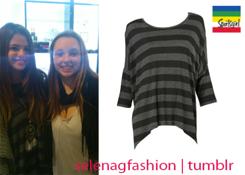 Selena got some shopping done while in Australia and picked up this Sportsgirl Stripe Longline top in color Blackgrey, this top can be yours for $49.95AUD! Buy it HERE! (Click &#8216;tops&#8217; then &#8216;long sleeve&#8217;)Check out a picture of Selena at the Sportsgirl store buying this shirt! (x)She paired it with a Sportsgirl oversized throw!