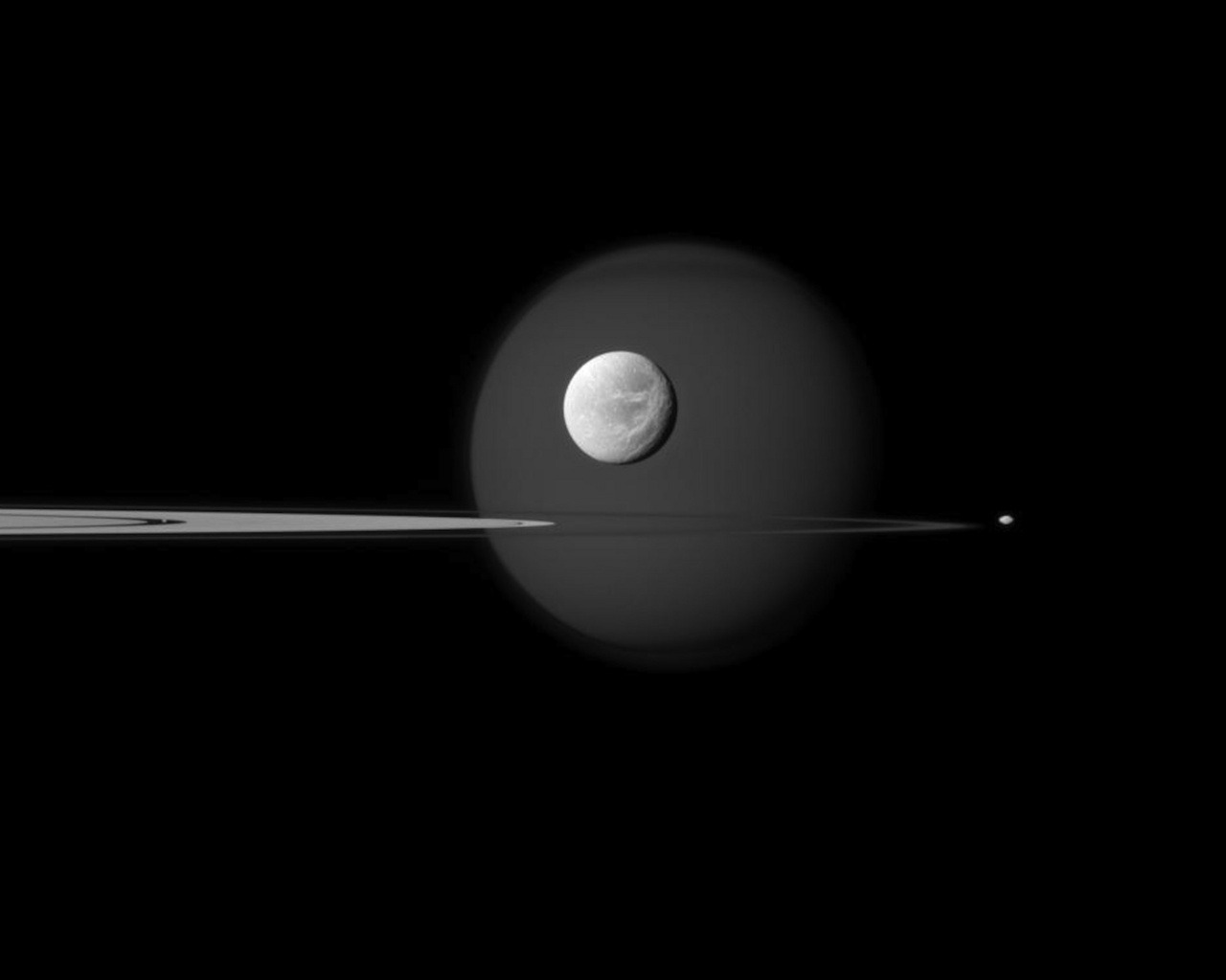 Seriously, Cassini … you need to stop taking such amazing pictures and let some of the other satellites have some fun. The rings of Saturn are framed by the moons Titan (rear) and the smaller Dione (front).  (via NASA/JPL and Space.com)