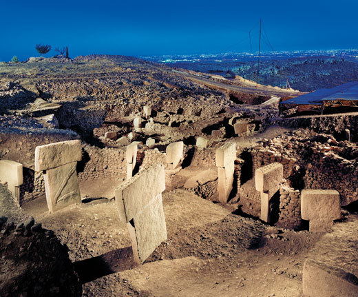 ancientpeoples:


Göbekli Tepe
South-eastern Turkey, 1994. German archaeologist Klaus Schmidt, while working in Şanlıurfa, comes across a hill known to the locals as Göbekli Tepe, or “Potbelly Hill”. The region had been surveyed before in the 1960’s, but researchers had deemed it of very little interest. Schmidt, however, saw that the site wasn’t a Byzantine cemetery, as had been suggested, but something much older.

Göbekli Tepe lies some eight miles from Şanlıurfa, in the north area of the Fertile Crescent, and rears up about 50 feet above the landscape. Schmidt and his team have been excavating here since ’94, and have unearthed quite the sight: on the hill, various circles of limestone pillars were erected. These pillars vary in height, with the highest being around 16 feet and weighing anywhere between seven and ten tons. The circles all have more or less the same layout: two T-shaped pillars in the middle, surrounded by smaller, inward facing stones. They all carry bas-reliefs of animals, in greater or lesser detail. 
Carbon-dating has shown that the limestone circles in Göbekli Tepe have been raised approximately 11,500 years ago - seven millennia before Stonehenge was built -, and has continued to be expanded upon until approximately 8,000 BC. The particular layout of the hill, more than 90% of which is still under the sand, has grown out of this expansion. There is evidence that the circles each at one point had been buried by the builders themselves, to be replaced by a new, smaller circle of stones. Strikingly enough, they seemed to have developed backwards: the earliest, larger circles show a remarkable sophistication of carving and construction not met by the newer ones. 
Underneath the rings, deep pit tests have revealed, are floors of hardened limestone. Many tools were found, which seems to suggest that the pillars were carved, if not directly on the hill, at least not far away from it. Another feature of the area is the presence of tens of thousands of animal bones. These bones seem to belong to animals slaughtered on site or close-by for food, and include gazelle bones and other game such as boars and deer, as well as various birds. There is no evidence, however, of a settlement on the hill, and it has therefore been suggested that Göbekli Tepe is a Neolithic religious centre: the earliest temple found to date. 
This would be supported by the appearance of the pillars, which might depict deities. The T-shape is reminiscent of a stylized human, and the animals that have been depicted are almost exclusively dangerous, deadly creatures: from scorpions to lions and vultures. The latter was in some cultures considered a vehicle that transported the dead towards heaven, which, together with the fragments of human bone that have been discovered, seems to suggest a cemetery.
The culture which is responsible for the construction of this site, is likely to have started out as a hunter-gatherer’s society, turned agricultural community some five centuries after. Why they choose to depict these particular animals instead of those they would hunt themselves, or even what the actual purpose of Göbekli Tepe was, is unknown. Six millennia before writing had been invented, the prehistoric context of the symbolism leaves us with no evidence to do anything but take wild stabs in the dark as to their meaning. 
Archaeologists, however, have their theories, one of which is the temple/burial ground theory Schmidt himself adheres. Other suggestions pertain to the idea that the builders depicted these dangerous animals in order to conquer their own fears, for example. For now, much remains uncertain, though when Schmidt and his team can penetrate the hill deeper and find out what lies underneath the limestone slabs, we might find out more about this peculiar site.
Images courtesy of Smithsonian Magazine
