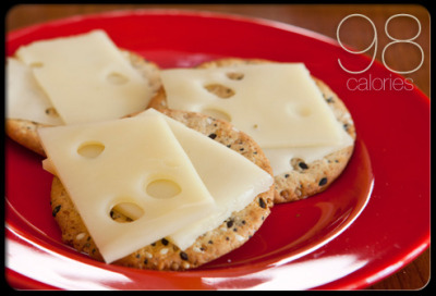 Three Crackers With Cheese
Choosing whole-grain crackers is the key to this classic snack. The fiber will keep you feeling full between meals, and the cheese provides protein and calcium. To stay under 100 calories, cut up one slice of low-fat cheese and split it over three crackers.
Saturated Fat: 1.2&#160;g
Sodium: 397&#160;mg
Cholesterol: 7&#160;mg
