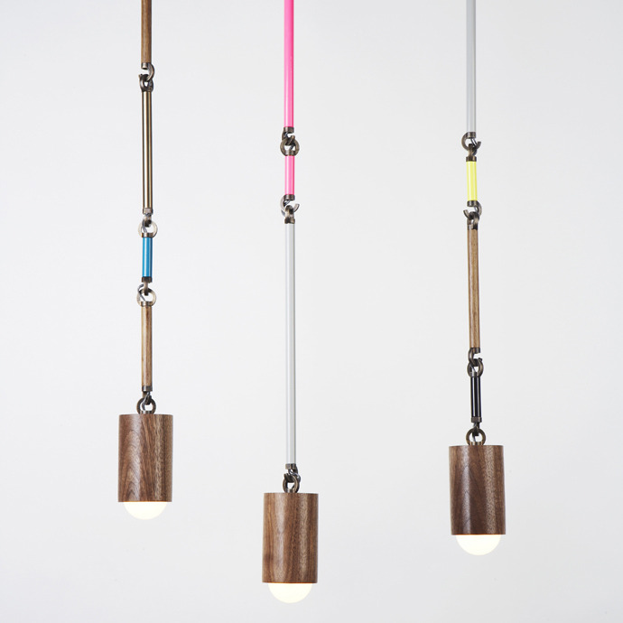 These rad pendants are called the Woodchuck Pendants by Lindsey Adelman. These walnut turned cylinders connected to powder coated metal tubing takes inspiration from the very tool called &#8220;the chuck&#8221; used for glass blowing. Lindsey has found a way to make small led pendants fun by changing the look of the bulb housing and the hardware that conceals the wiring. Love!