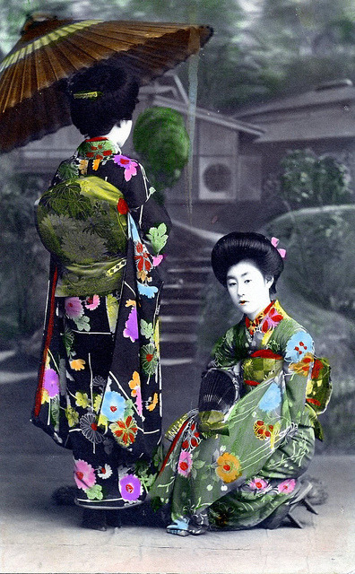 Hand-colored postcard -two Hangyoku (Young Geisha) holding paper umbrellas, 1910
via