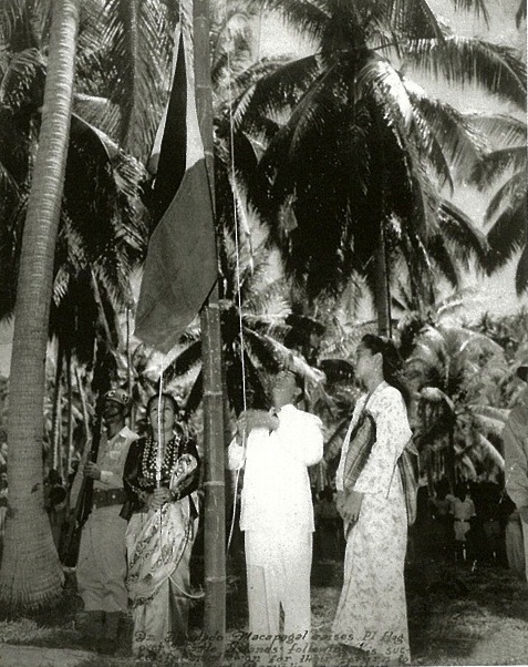 Atty. Diosdado Macapagal raises the Philippine flag at Turtle Islands.<br />The caption reads:<br /><br />Atty. Macapagal got his first break as a public figure in 1948 when Vice President Quirino, then concurrently Secretary of Foreign Affairs, appointed him as Assistant Chief of its Law Division and assigned him to negotiate the return of the administration of the Turtle Islands from the United Kingdom to the Philippines. He succeeded and [Vice President] Quirino gave him the privilege of raising the Philippine flag over the islands. <br />- From Nipa Hut to Presidential Palace by Diosdado Macapagal<br />