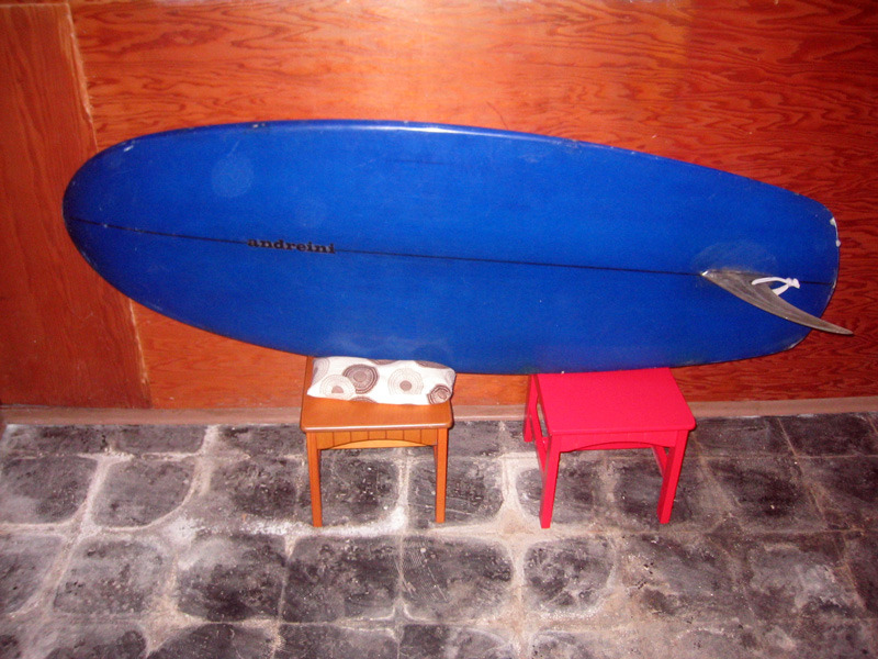 I made this board between 71&amp;72&#8217;. It is a Greenough style knee board and not a stand up board. The bottom has my first andreini logo that I made from run on letters from the art store. It looks like the customer gave me the script of his initials for the deck. I would have made that board at my shop on Ocean View ave in Santa Barbara. It was an old barn behind an old Victorian house full of hippie renters! I don&#8217;t remember the board very clearly but I regularly made knee boards as it was very popular in the early years of the transition because George Greenough, who rode a similar board, ushered in the short board revolution. He was my main inspiration in board design and still is. 
Thanks Justin from DC for sending over the pictures. He found it while living in Seattle at the time and wanted some more info on it!