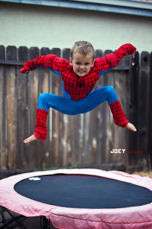 [Image Description: Maskless Spider-Man jumps up into a perfect pose on a trampoline.]
