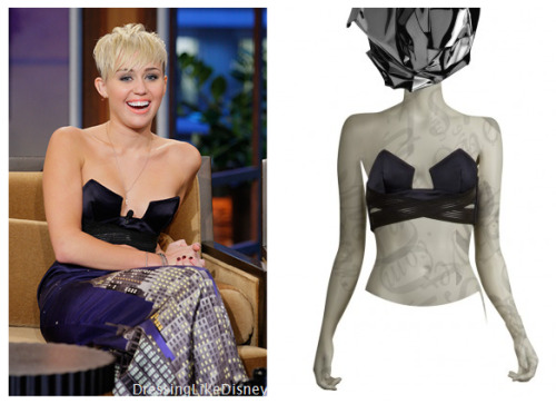 Miley Cyrus wears this Anthony Vaccarello Bustier Criss Cross Top in navy on the Tonight Show with Jay Leno on Friday    You can buy the exact navy top HERE for $1040  Green HERE for $1040and Gold HERE for $979I tried to look around for similar cheaper options, but the only think i came up was this Evil Twin &#8216;Cross To Bare&#8217; Lace Front Bustier from ASOS HERE for $39Or a studded one HERE from Forever21