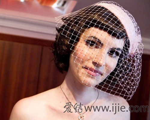 The second photo shows a head shot of a European woman wearing a very small white hat with a white net-like veil over the small hat. The veil has no opening, but her face can be clearly seen through the veil. The bottom-right corner credits the photo to the web site www.ijie.com.
