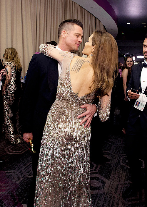  Brad Pitt and Angelina Jolie share an intimate moment backstage at the 86th Annual Academy Awards 