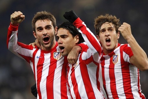 Atletico Madrid's Falcao (C) celebrates with his teammates Adrian (L) and Koke after scoring his second goal against SS Lazio during their Europa League last 32 first leg soccer match at the Olympic stadium in Rome February 16, 2012. REUTERS/Tony Gentile  (ITALY - Tags: SPORT SOCCER)x