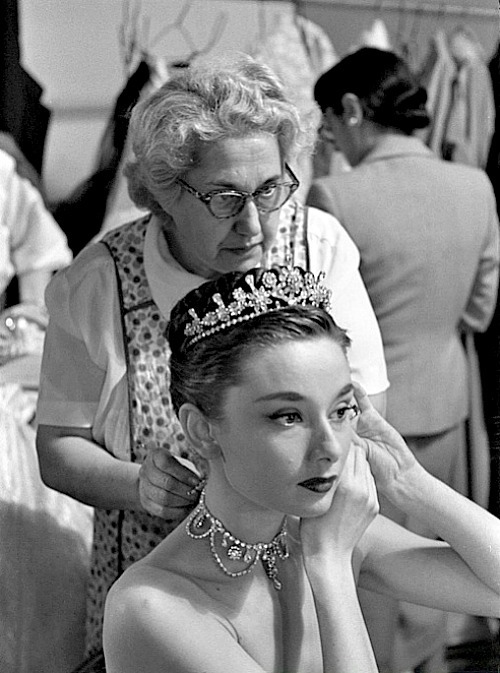  Audrey Hepburn on the set of Roman Holiday getting her necklace put on by her dresser Sally Gordon, 1952. 
