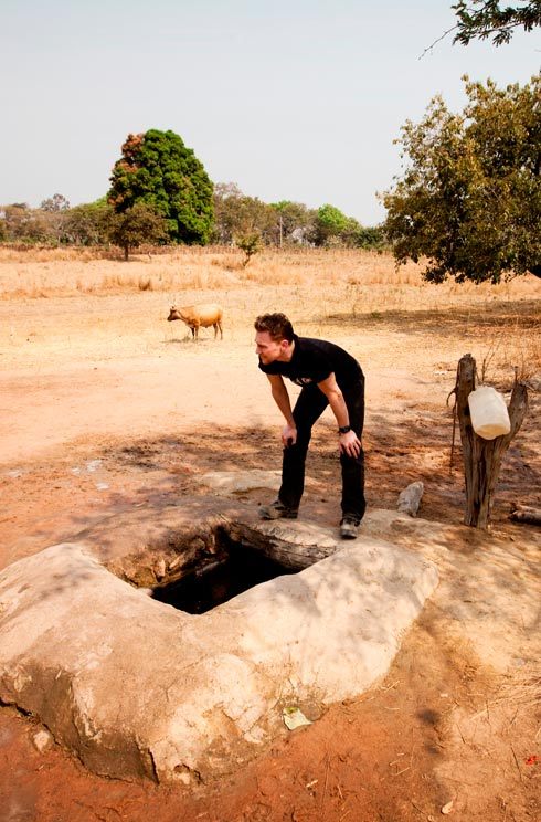 Tom overlooking the deep well in the village of Loppe and the distances that families have to walk to receive