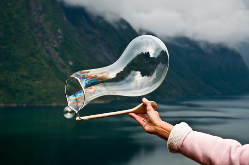 Creating soap bubbles over the fjord with a string and a spoon (by Odin Hole Standal) 