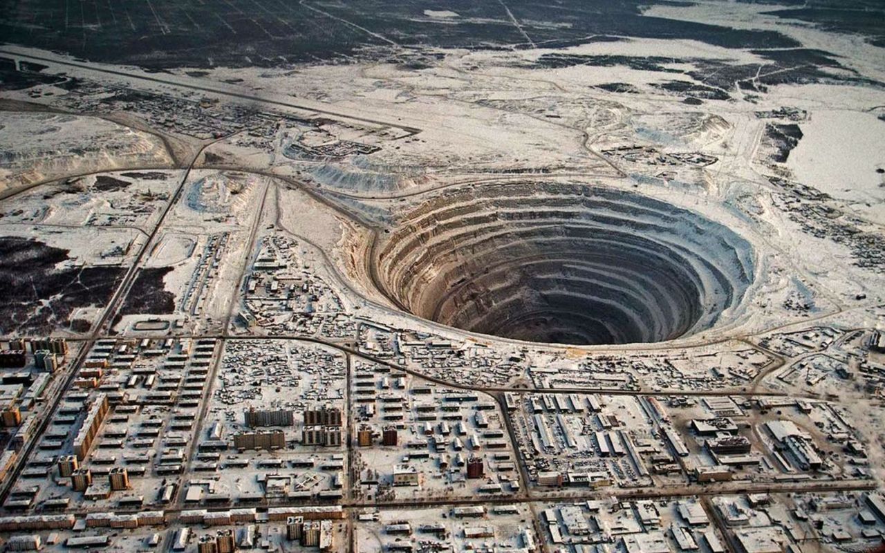 peterfromtexas: Mirny Diamond Mine The diamond mind in Mirny, Russia, a small town in eastern Siberia, is the second largest man-made hole in the world. At 1,722 meters deep, it takes one hour to drive to the bottom. 
