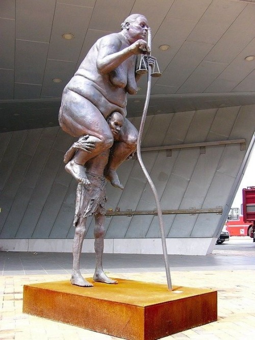 Sculpture depicting the weight of government on the common man.
