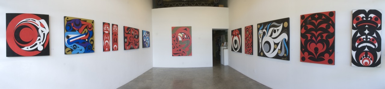 Gallery room full of canvases painted in West Coast art style