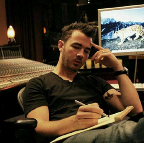 Kevin in the studio and his new tattoo.